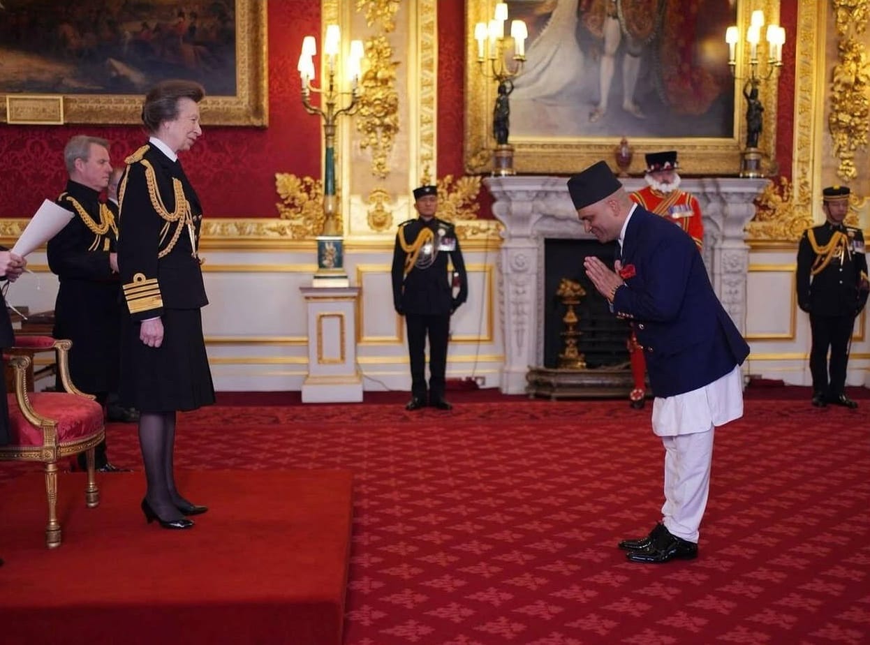 A person receiving an award, bowing to the person presenting them with their award.