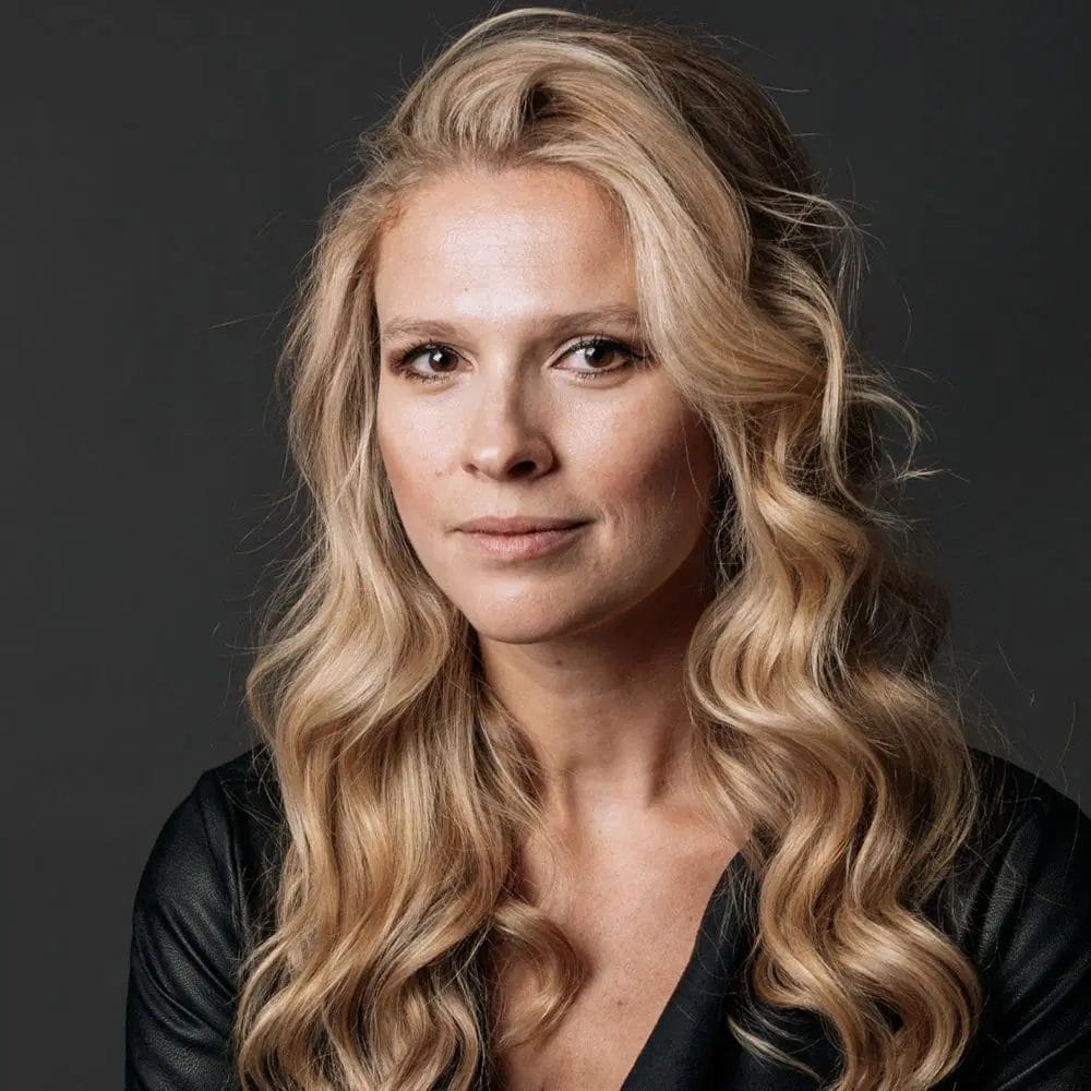 A headshot of Irra Ariella Khi, wearing a black top.